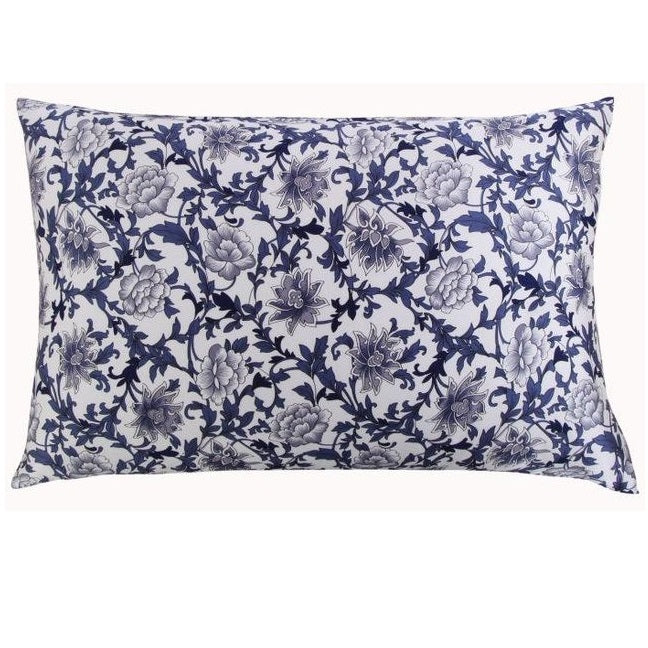 Floral patterned pillowcase with blue and white design on a white background