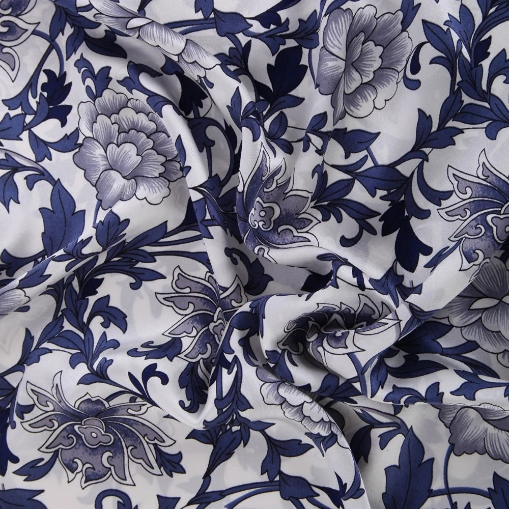Floral patterned fabric with blue and gray design on white background