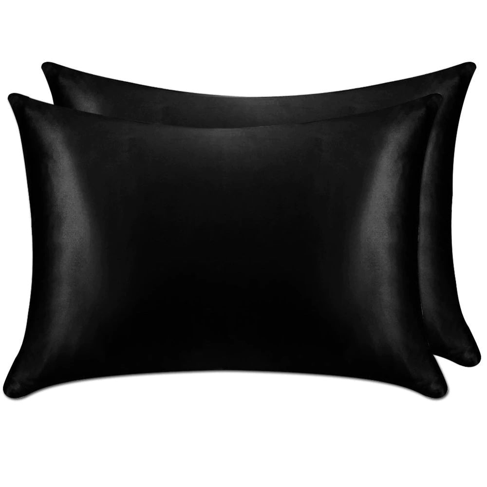 Two black satin pillowcases on a white background