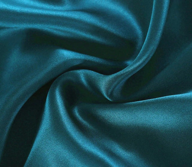 Close-up of teal fabric with folds