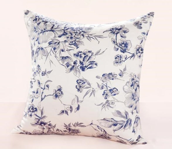 Floral-patterned pillow with blue flowers on a white background