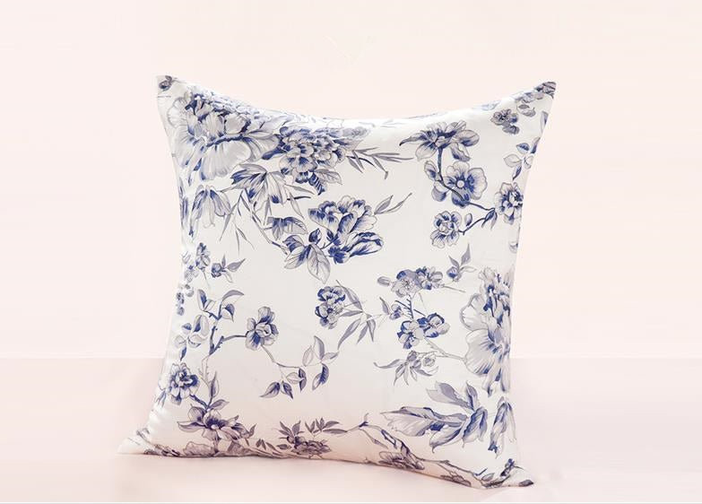 Floral-patterned pillow on a light pink background