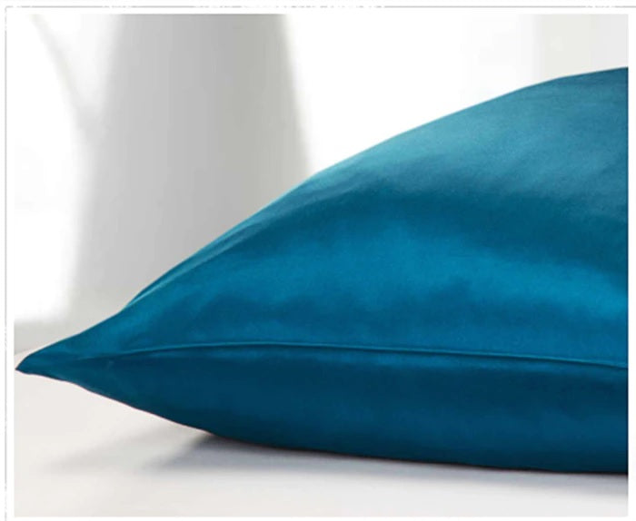 Teal pillow on a white background