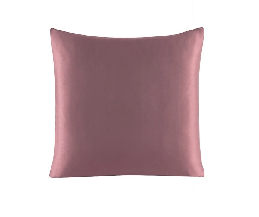 Pink satin pillow on a white background