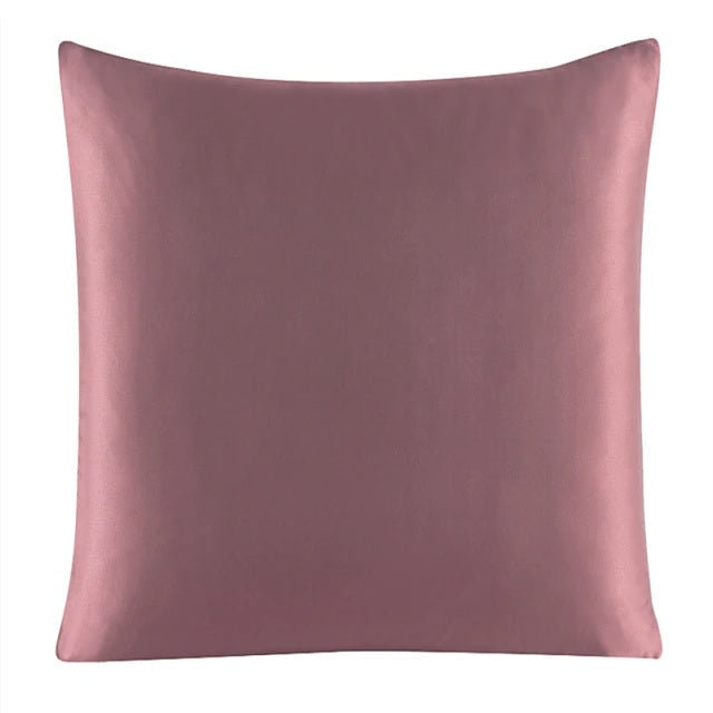 Pink satin pillow on a white background