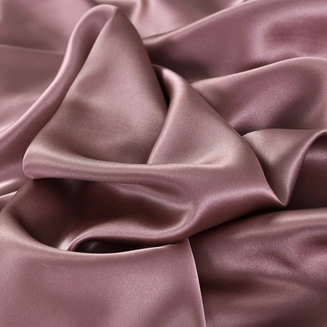 Close-up of smooth, purple fabric with folds