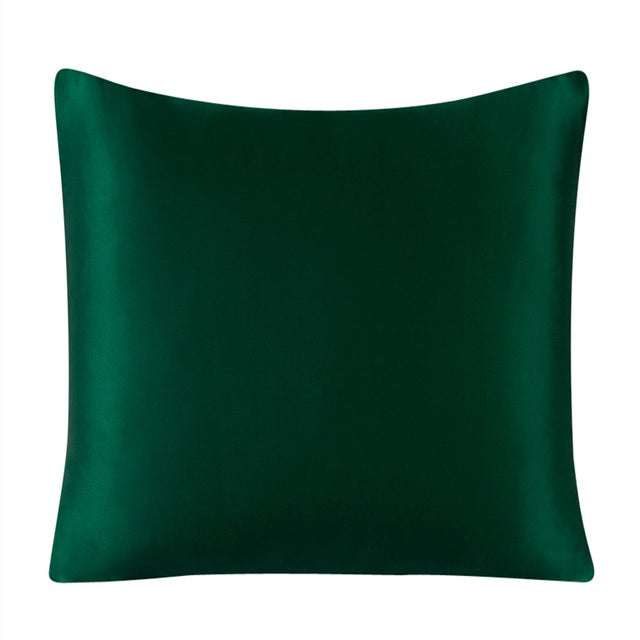 Green satin pillow on a white background
