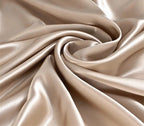 Close-up of beige satin fabric with folds
