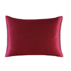 Red satin pillow on a white background