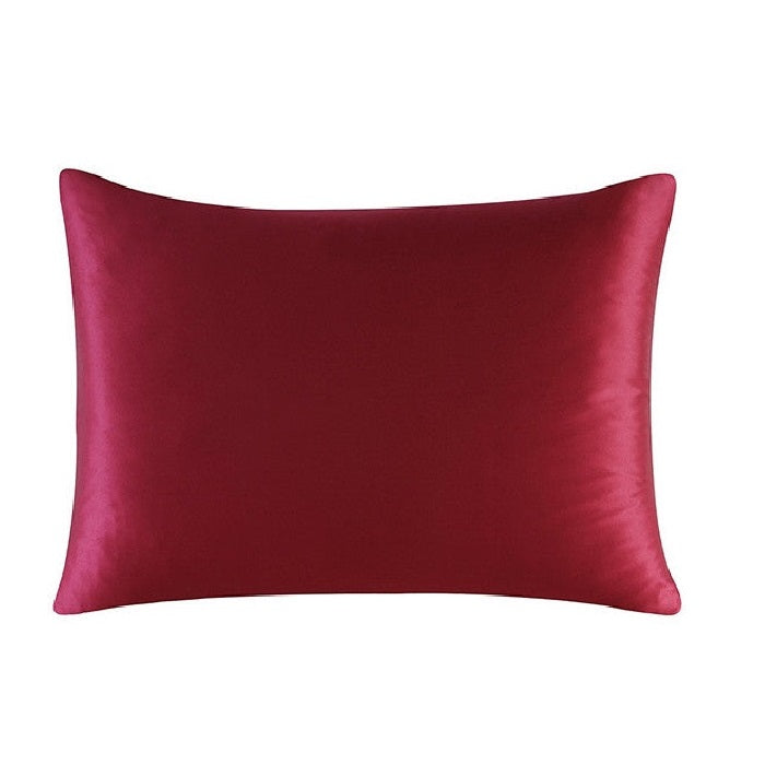 Red satin pillow on a white background
