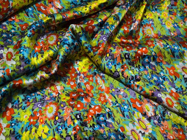 Colorful floral fabric with a pattern of various flowers in multiple colors.