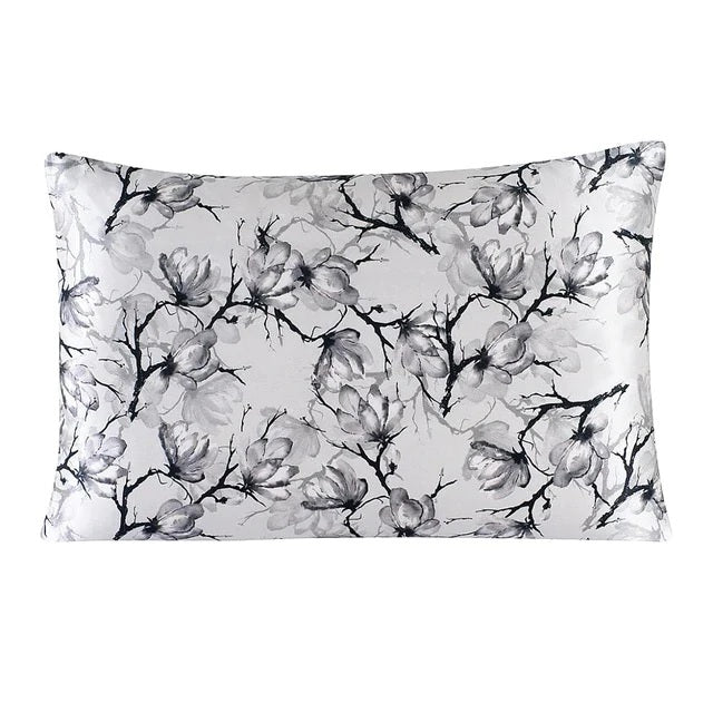 Floral patterned pillowcase with black and gray flowers on a white background