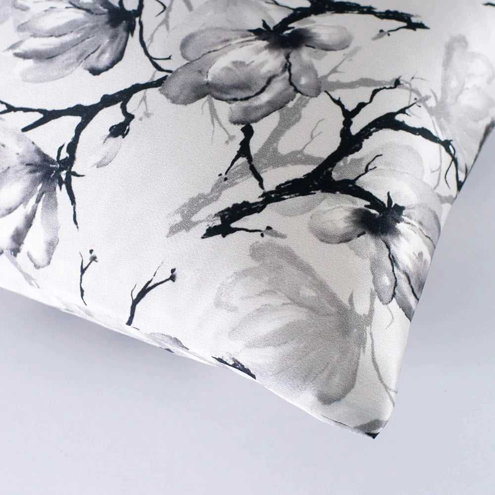 Floral patterned fabric with black and white flowers on a light gray background