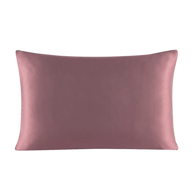 Pink satin pillowcase on a white background