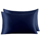 Two navy blue satin pillowcases on a white background