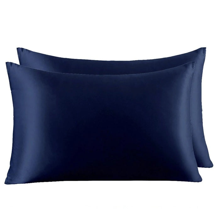 Two navy blue satin pillowcases on a white background