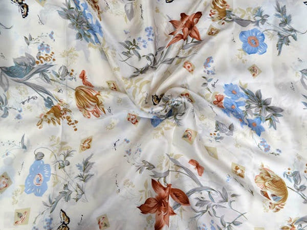 Floral fabric with colorful flowers and leaves on a white background