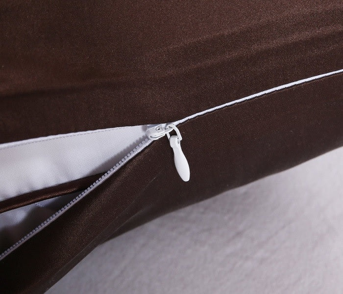 Close-up of a zipper on a brown garment with a white background